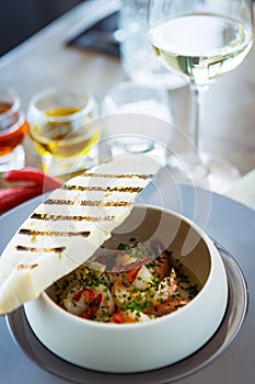 Shrimp pil-pil. King prawns, garlic, chilli and baguette. Delicious Spanish traditional food closeup served for lunch in