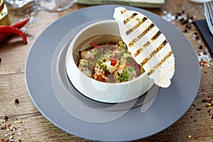 Shrimp pil-pil. King prawns, garlic, chilli and baguette. Delicious Spanish traditional food closeup served for lunch in