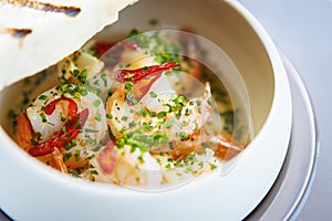 Shrimp pil-pil. King prawns, garlic, chilli and baguette. Delicious Spanish traditional food closeup served for lunch in