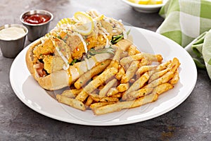 Shrimp po boy sandwich with fries