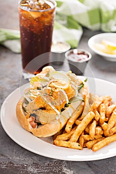 Shrimp po boy sandwich with fries