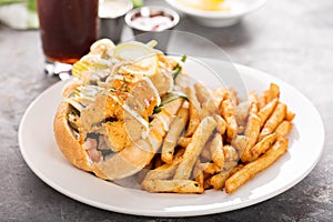 Shrimp po boy sandwich with fries photo