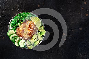 Shrimp poke bowl with avocado, cucumbers, wakame, and lime, shot