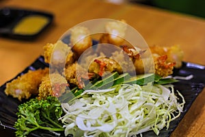 Shrimp tempura prepared with vegetables on a plate