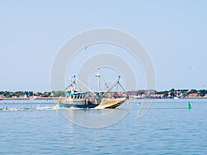 Shrimp trawler fishing off coast of Frisian island Vlieland on a photo