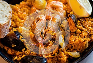 Shrimps in paella, traditional Mediterranean food in a restaurant plate. Seafood