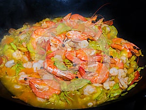 Shrimps, Prawns, marrows and carrots cooked in a smoking pan