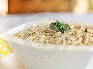 Shrimps RISOTTO topping with coriander closeup served in pot isolated on table side view of arabic food