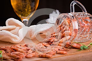 Shrimps on a wooden board end glass of beer