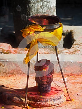 Shrine covered in vermillion to worship Goddess Kali. Red pigment powder on statue in Dhulikhel, Nepal