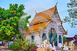 The shrine, guarded by elephants, Wat Sangkharam Temple, Lamphun, Thailand photo