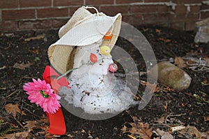 Shrinking melted snowman in a hat and flower photo