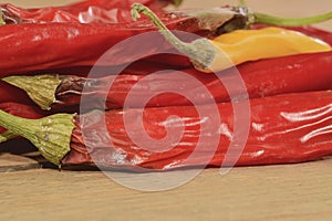 Shrinking and mould chili peppers on wooden background. Rotten chili peppers. Flat design photo
