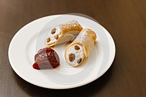 Shrovetide Maslenitsa Butter Week festival meal. A pair of Russian pancakes with orange jam on a dark table. Traditional Pancake