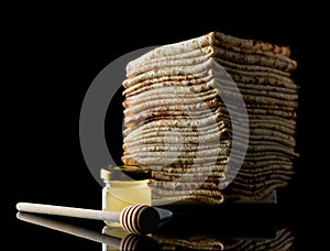 Shrovetide Maslenitsa Butter Week festival meal. Stack of russian pancake blini on a dark rustic wooden background