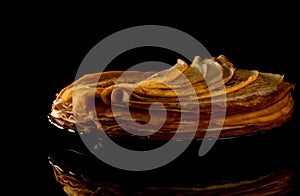 Shrovetide Maslenitsa Butter Week festival meal. Stack of russian pancake blini on a dark rustic wooden background