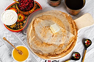 Shrovetide Maslenitsa festival. Russian pancakes blini. Pancakes with honey and jam. Russian spoons. National russian