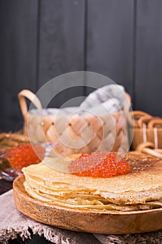 Shrovetide Maslenitsa Week festival meal. Stack of russian pancakes with red caviar. Rustic style, free space for text.