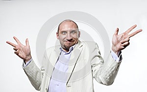 Shrugging man in doubt and surprise doing shrug showing open palms photo
