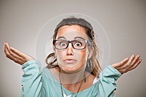 Shrugging woman in doubt doing shrug showing open palms. photo