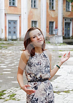 She shrugs surprise against the backdrop of an building