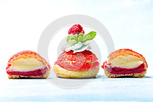 Shu cake. Custard dessert with creamy white cream, decorated with raspberries