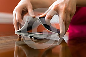 Shuffling a Deck of Cards on a Reflective Table