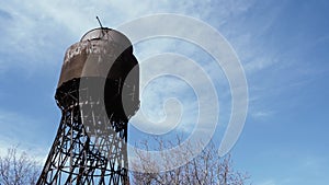 Shukhov's metal water tower against the blue sky. Big capacity for water, the tank on a metal support. The concept