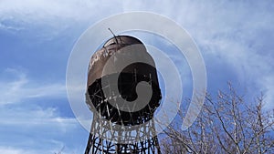 Shukhov's metal water tower against the blue sky timelapce. Big capacity for water, the tank on a metal support. The