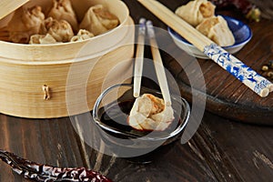 Shumai shaomai Chinese meat dumpling steamed dish in bamboo steamer box. Name dim sum