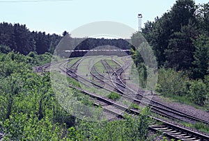 Shunting electric locomotive and coupling of freight cars on different tracks of railway goods station tracks intersection.