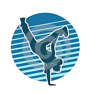silhouette of a female dancer doing handstand breakdance.
