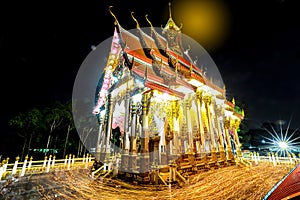Shutter Bulbs image of Triple Circumambulation at the buddha church in night, People walking with candle light around buddha photo