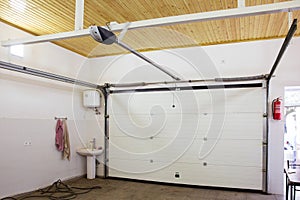 Shutter door or roller door and concrete floor outside .White Automatic shutters in a house . gates in the garage . Automatic