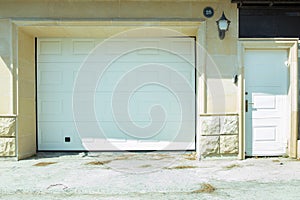 Shutter door or roller door and concrete floor outside .White Automatic shutters in a house . gates in the garage . Automatic