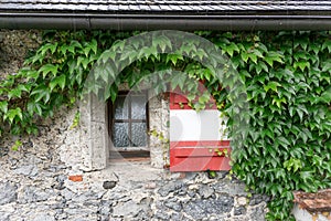 Shutter on the window of the castle wall in red and white like the Austrian flag