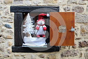 Shutter window with only one wooden board and christmas decorations