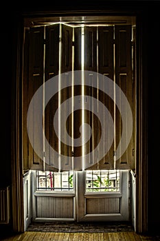 Shutters over tall french doors in old European bilding - view at bottom shows view from upstairs