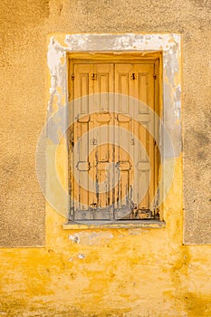 Shutters on wall background. Building exterior of faded wall and shutters. Design in building architecture. Closed