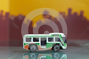 Shuttle touring bus toy selective focus on blur city background