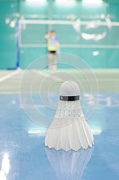 shuttlecock on the floor with badminton player