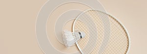 Shuttlecock and racket for playing badminton on a cream background. Concept summer game