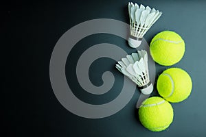 Shuttlecock and Tennis ball on black background with co