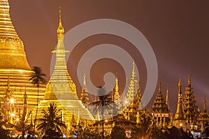 Shwedagon Pagoda at night with spotlight reflects gold surface of The pagoda