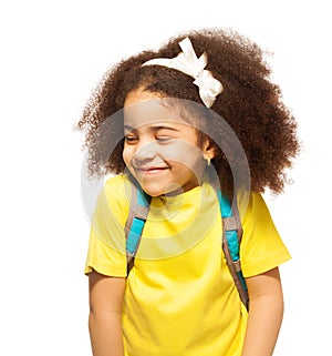 Shy African girl with white bow, closed eyes