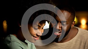 Shy afro-american couple on night date, tender feelings, trust and closeness