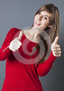 Shy beautiful young woman smiling with thumbs up