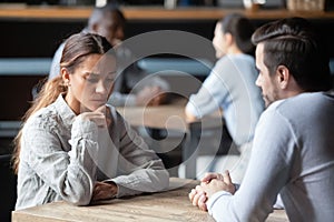 Shy or bored woman sitting with man on speed dating