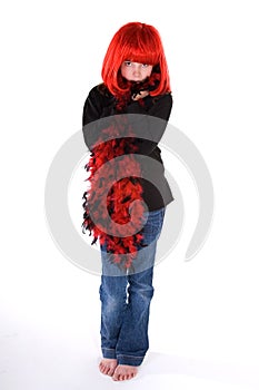 Shy girl in red wig and boa.