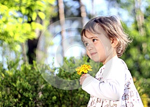 Shy girl with yellow flower photo